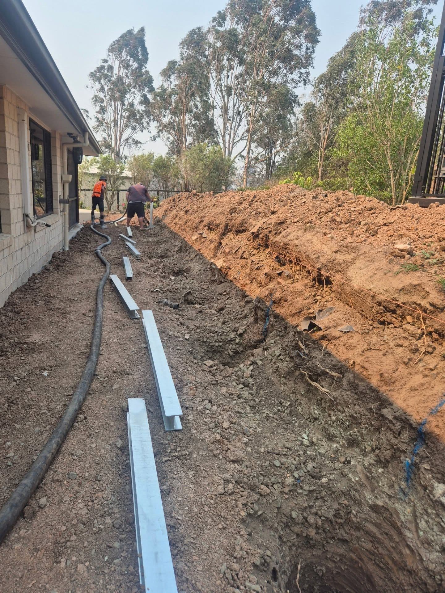 Ag line laid in the drainage trench behind a wall